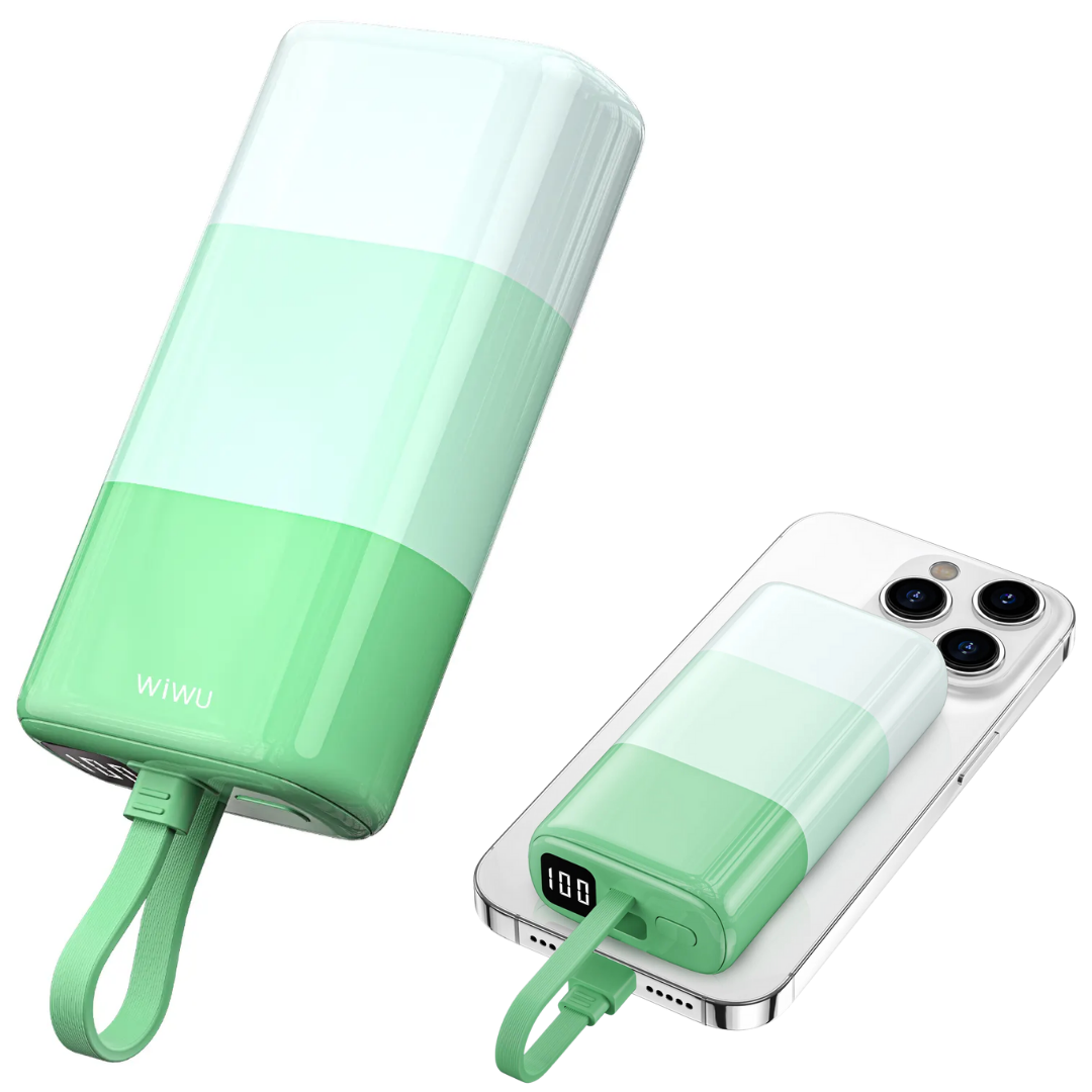 Pastel green WiWU power banks in two positions—one vertical, one horizontal—charging an iPhone using built-in cable, with LED display showing 100% battery power and visible power on/off button.