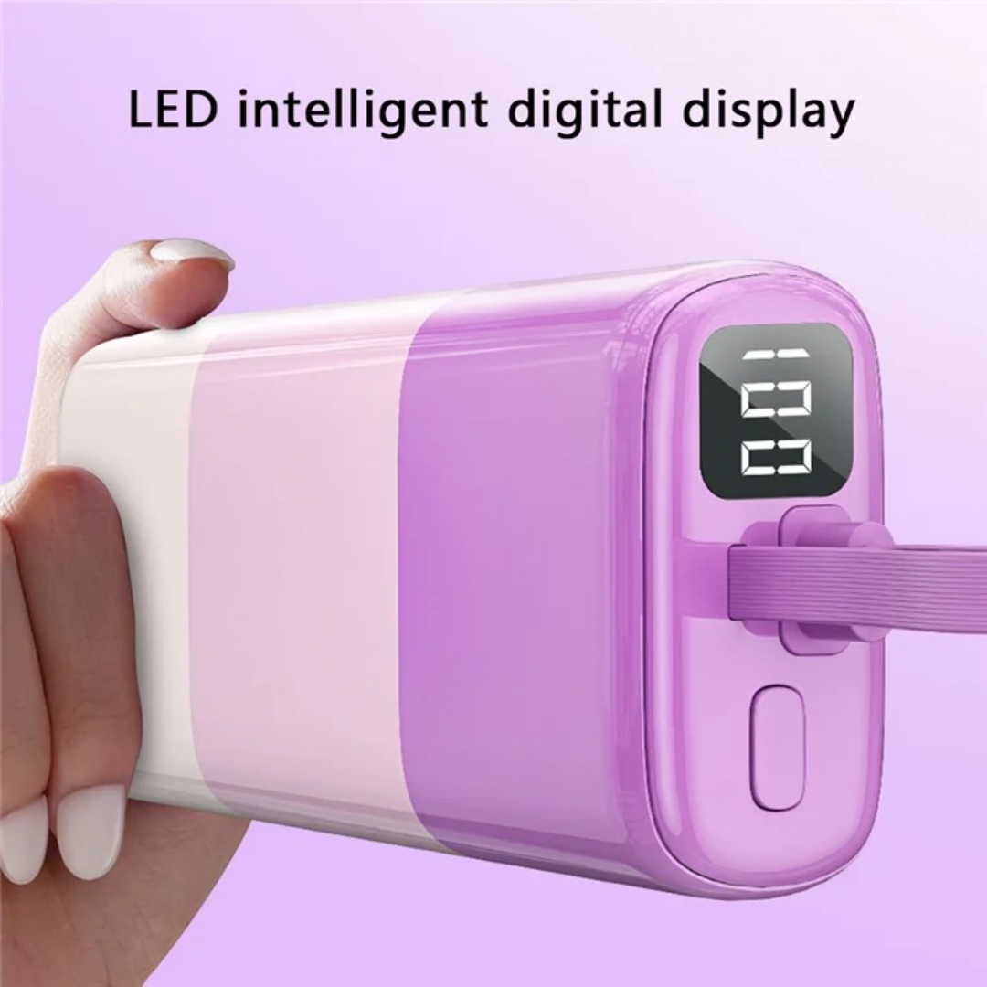 Woman’s hand holding pastel purple WiWU power bank with built-in charging cable and LED display facing outward, showing battery charge level for convenient on-the-go charging.