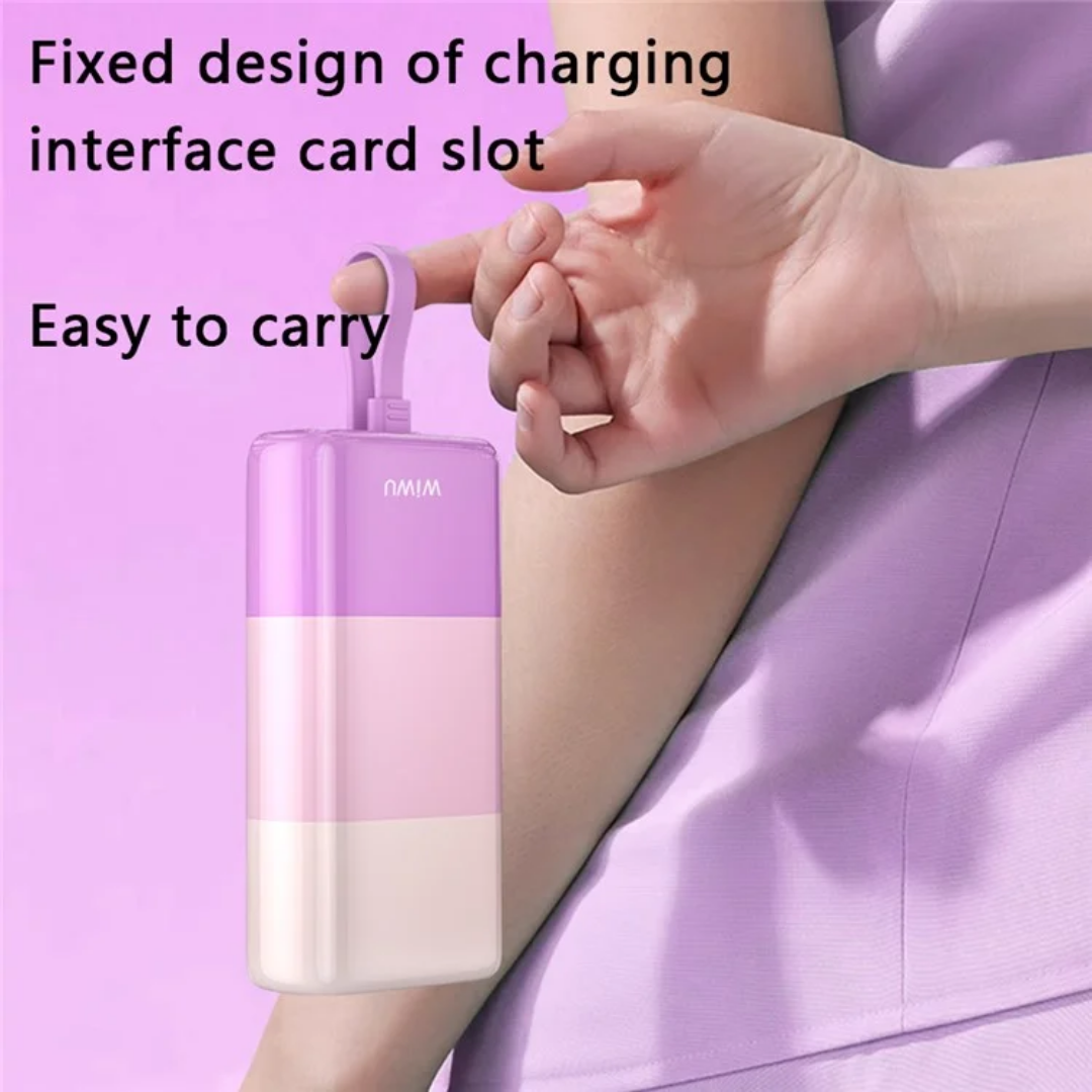 Woman’s hand holding pastel purple WiWU power bank by its built-in charging cable, demonstrating easy-to-carry lanyard-style design and fixed charging interface card slot against a matching purple background.