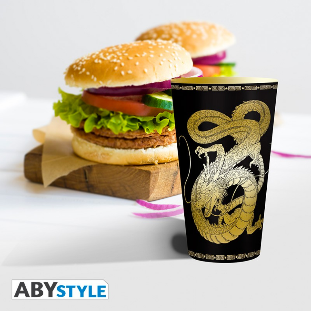 Dragon Ball Z 400ml glass with gold Shenron dragon design by ABYstyle, placed beside burgers on a table.