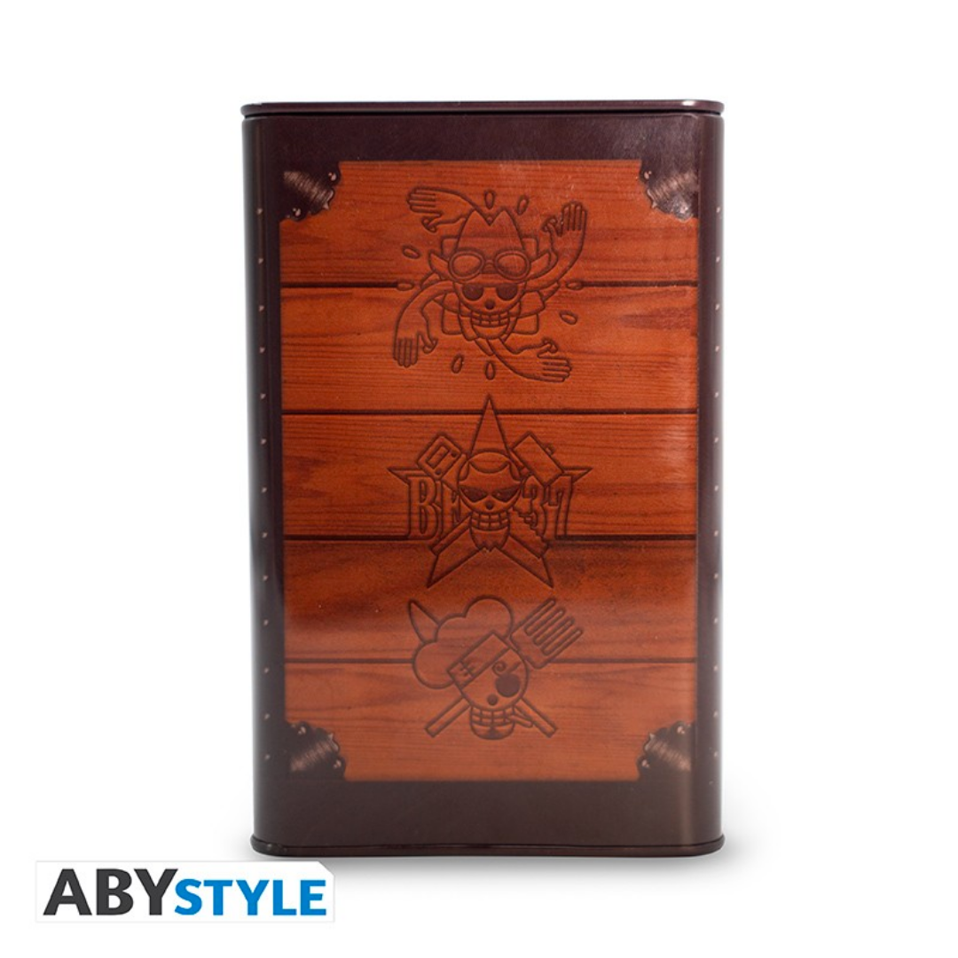 One Piece metal money box by ABYstyle featuring a treasure chest design with engraved Jolly Roger symbols of different pirate crews.
