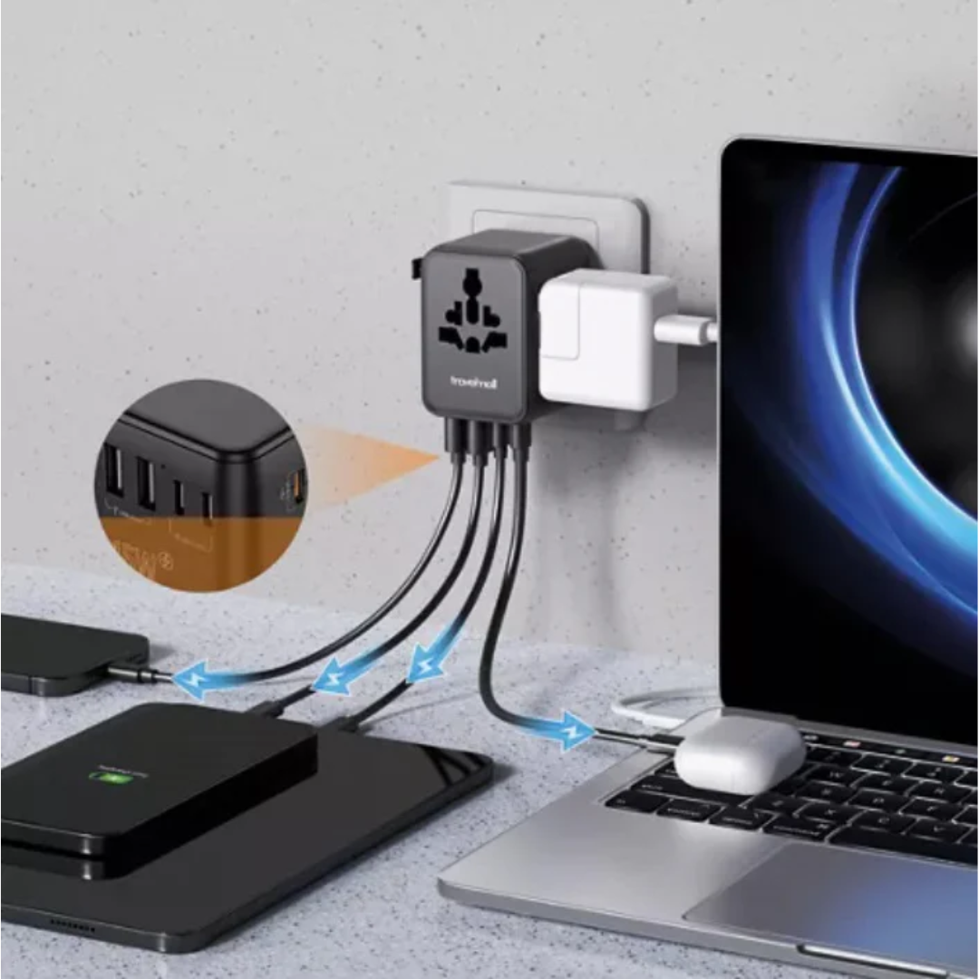 World travel adapter charging a laptop and smartphone simultaneously.