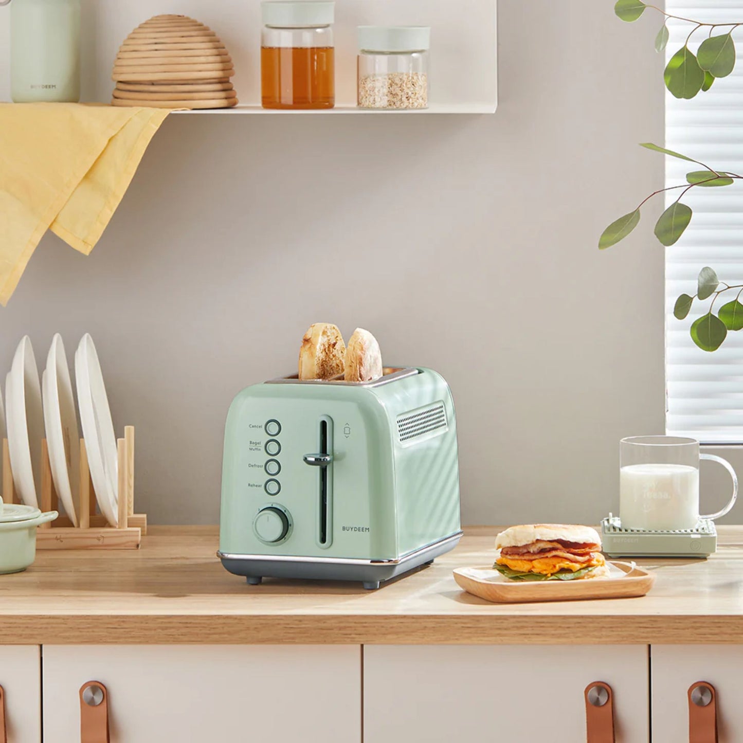 Buydeem 2-Slice Toaster Cozy Greenish toasting English muffins on kitchen counter with milk and breakfast sandwich