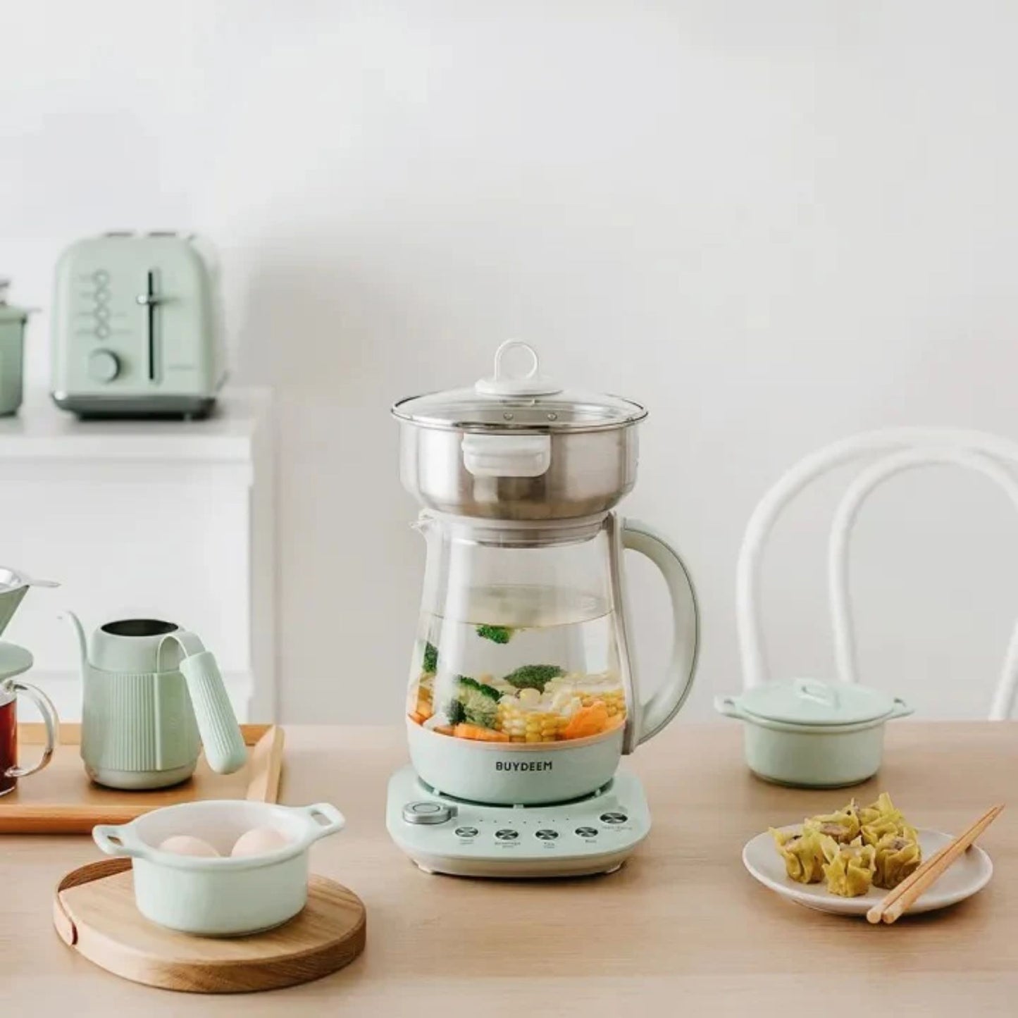 Buydeem Multi-Functional 4-in-1 Health Pot with steamer cooking soup and vegetables, modern kitchen breakfast setup