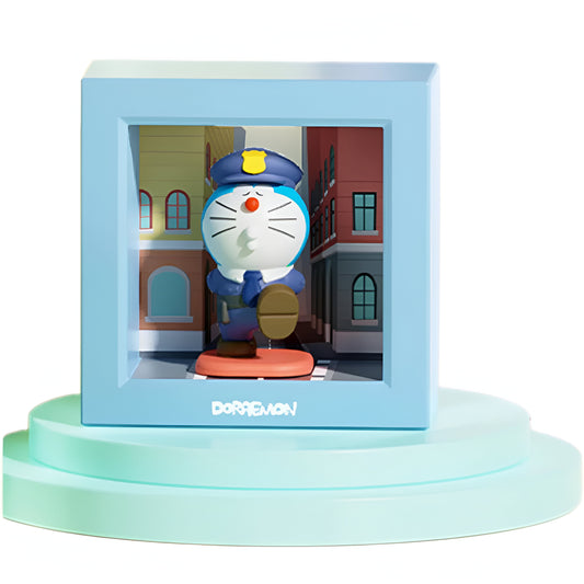 Doraemon collectible figure dressed as a police officer, standing in a blue display box with a city street background, placed on pastel blue podiums, official Doraemon logo on the box
