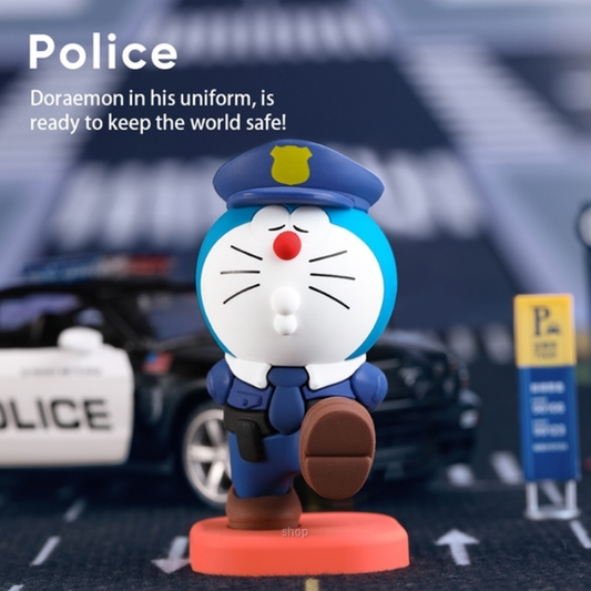 Doraemon collectible figure dressed as a police officer in blue uniform and cap, marching with one leg raised, displayed on a city street background with a police car and parking sign, "Police: Doraemon in his uniform is ready to keep the world safe!" text above