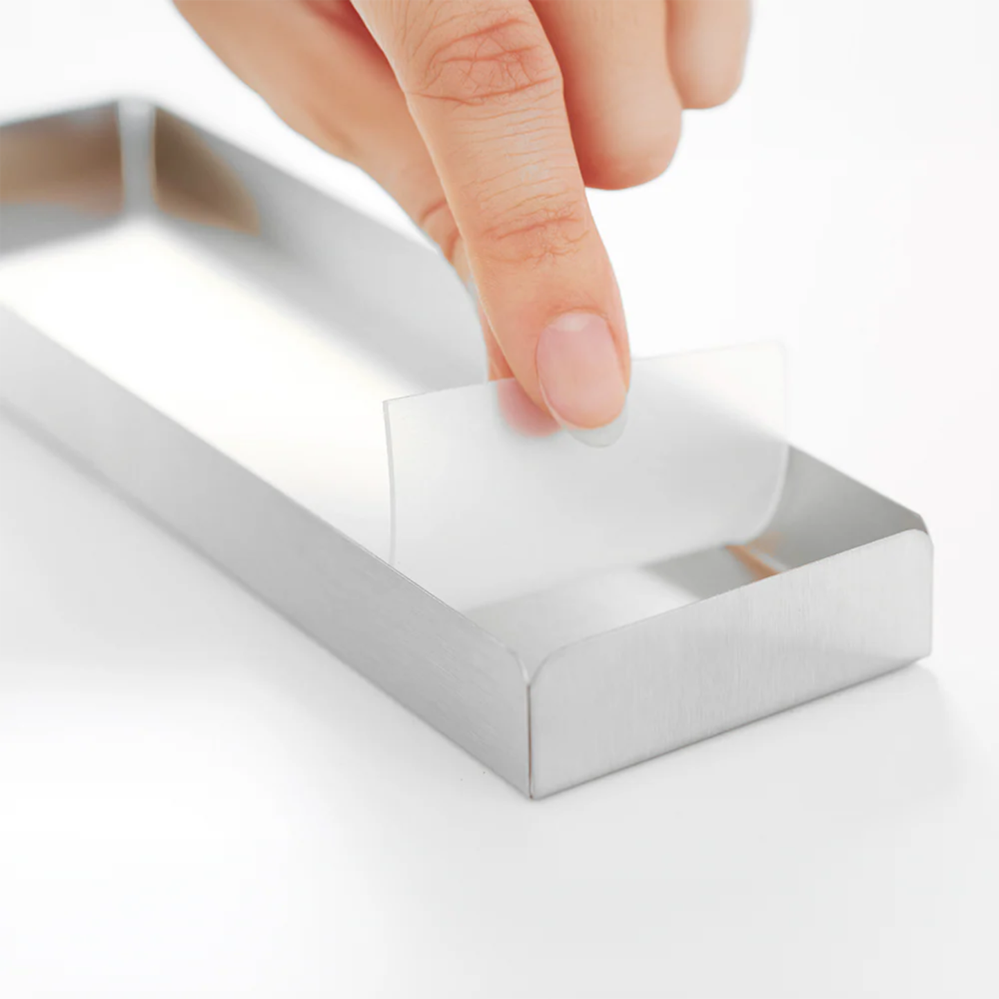 Close-up of Hanauta stainless steel kitchen rack’s removable drainage tray, highlighting easy cleaning and hygienic utensil storage solution for kitchens.