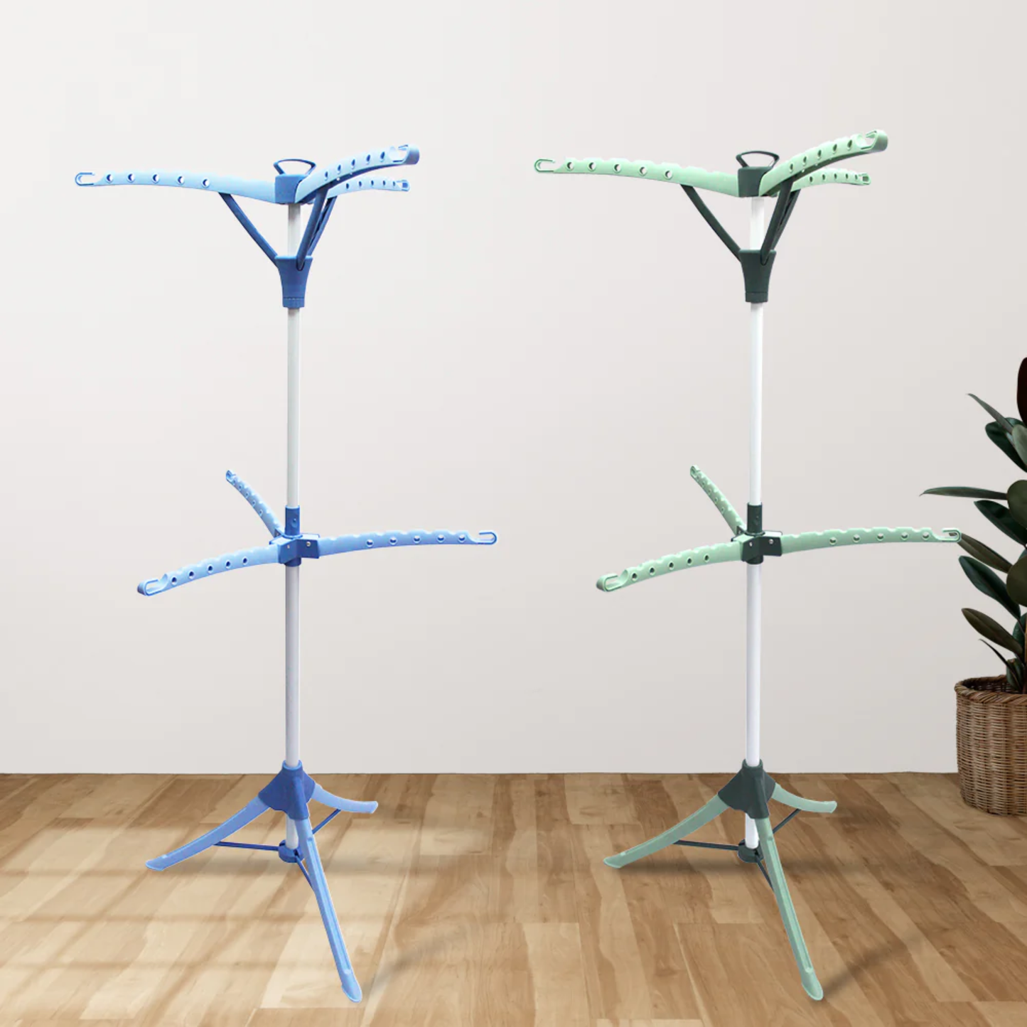 Blue and green two-tier foldable laundry drying racks with multi-arm design standing on wooden floor indoors
