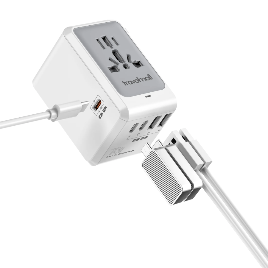 Travelmall universal power adapter with multi-standard socket, UK/US/EU/AU retractable plugs, USB-C fast charging port, and multiple USB-A ports for global device charging.