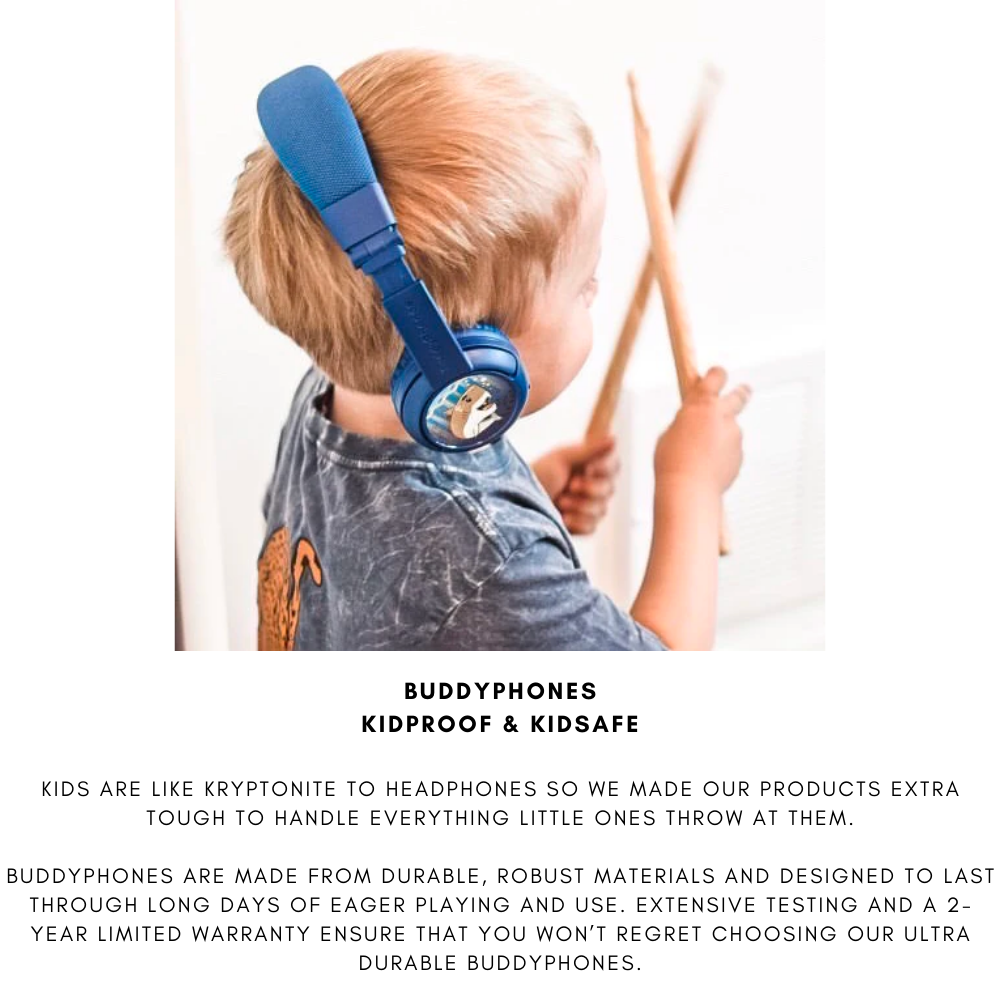 Young boy with blond hair wearing blue over-ear BuddyPhones headphones featuring a cartoon animal design, playing with drumsticks in a bright indoor setting.