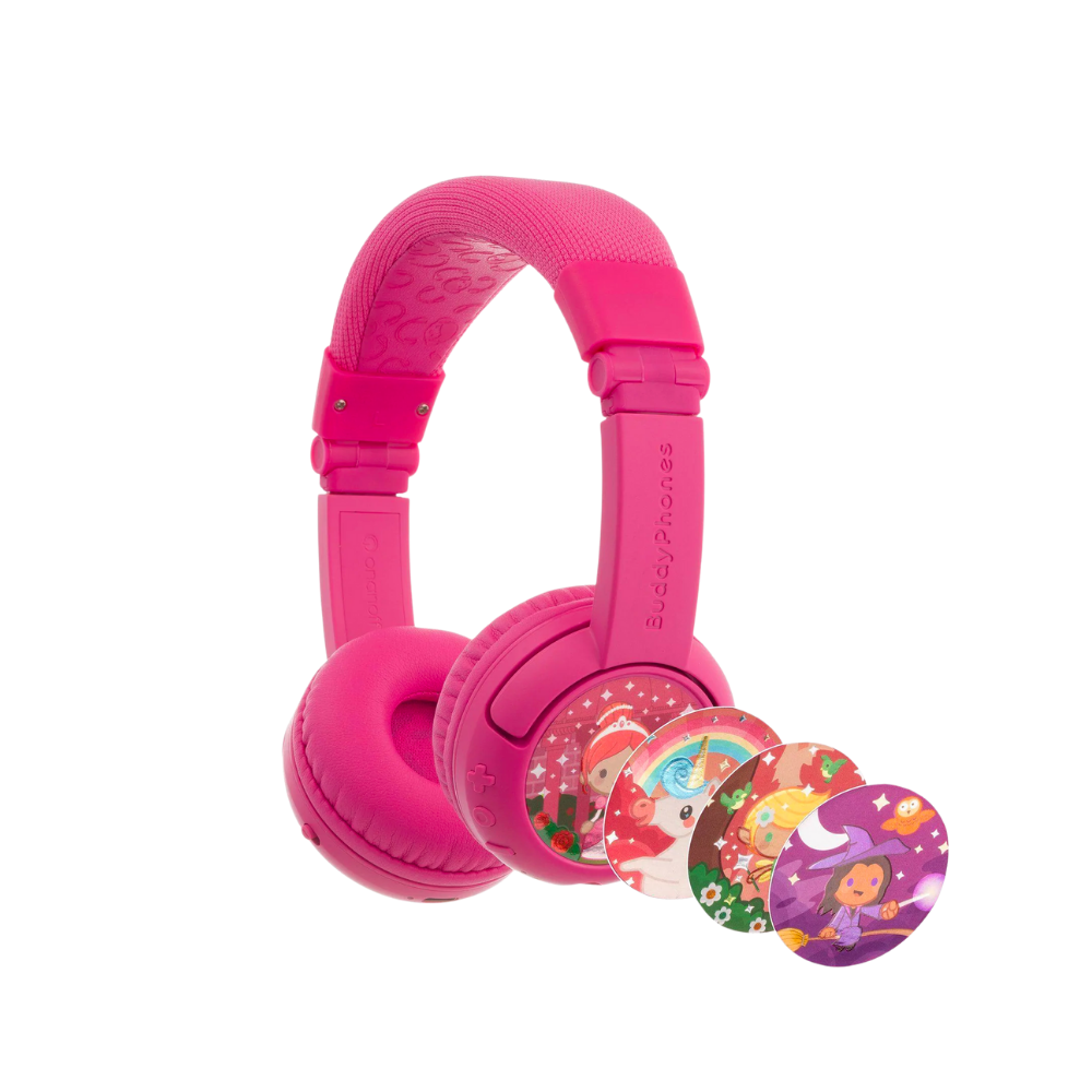 Bright pink over-ear kids’ headphones with a cushioned headband, shown with four interchangeable decorative discs featuring whimsical fairy tale characters, including a unicorn, princess, Santa Claus, and a witch.