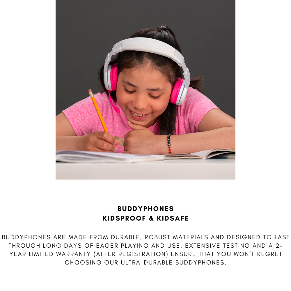 Girl wearing white and pink over-ear headphones and a pink shirt, writing in a notebook at a desk with an open book, against a dark background; text below highlights BuddyPhones’ kidproof and kidsafe durability.