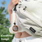 Close-up of a portable WiWU bladeless handheld fan with digital display, attached to a waist bag using its built-in carabiner design, perfect for hands-free personal cooling and travel convenience outdoors.