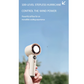 Hand holding a portable bladeless handheld fan with digital display, set against a clear blue sky. The fan features 100-level stepless wind control for customizable and powerful cooling, ideal for outdoor summer comfort.