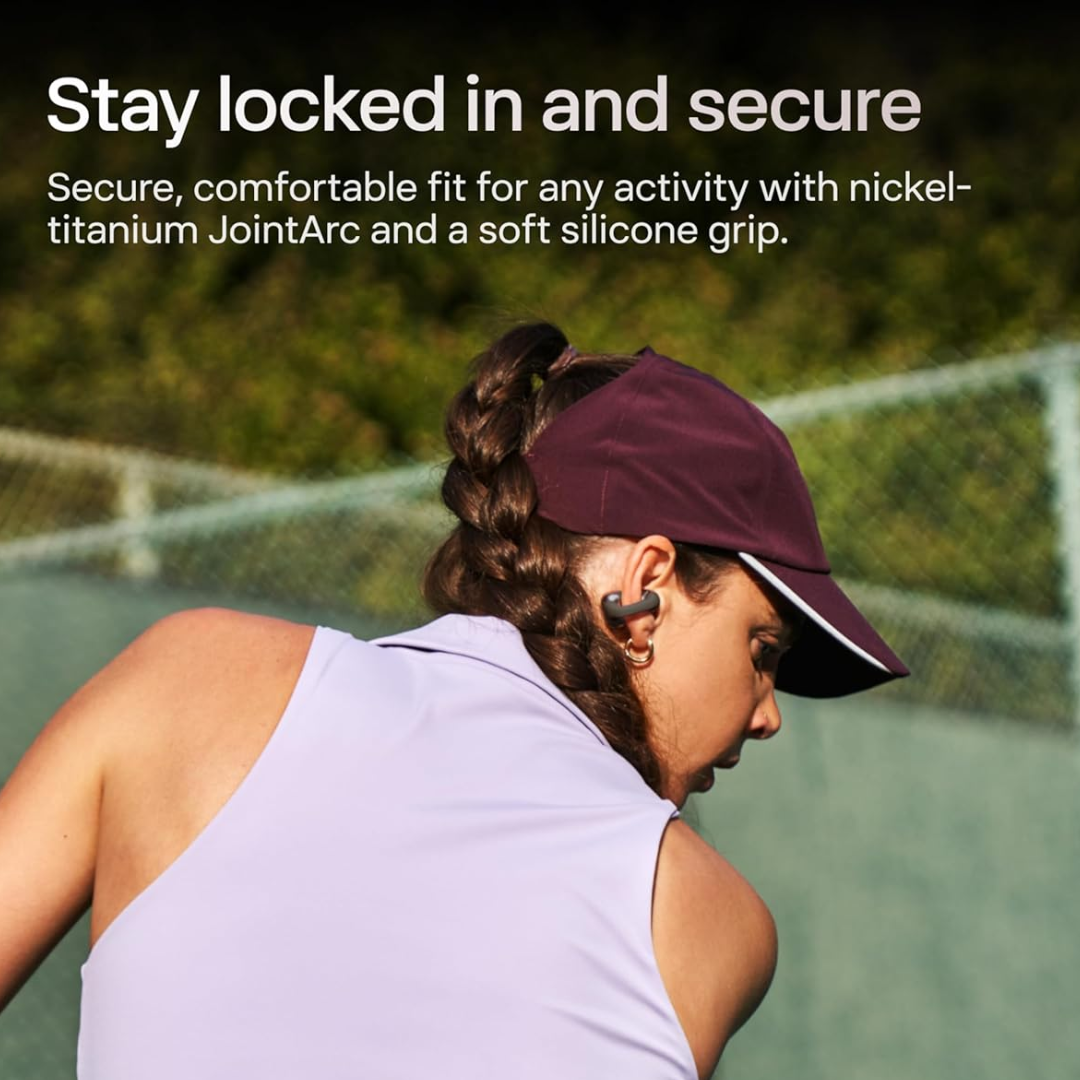 Woman wearing Shokz OpenDots ONE clip-on open-ear earbuds during a run