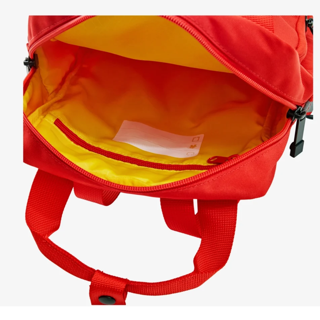 Close-up of the backpack in low light, highlighting one of the four reflective details for safety.