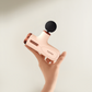Hand holding Beoka C1 Max Mini Massage Gun, compact and portable deep tissue massager with adjustable intensity for muscle recovery.
