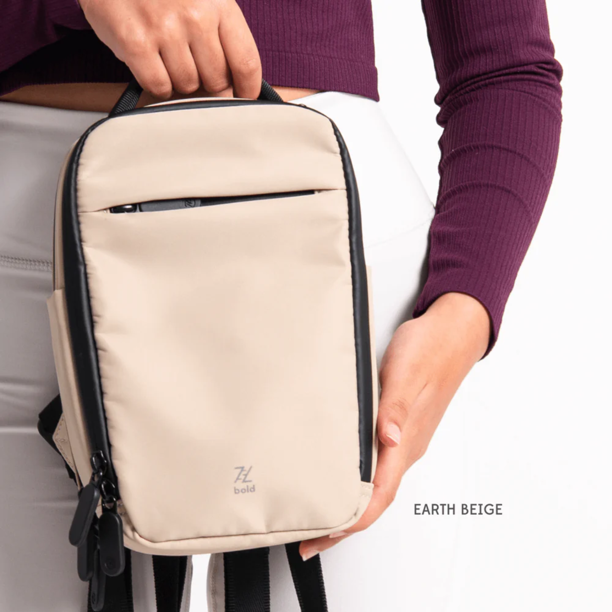 Bold Mimic Sling Bag in earth beige, held by model in hand; minimalist, versatile crossbody bag for travel and daily use.