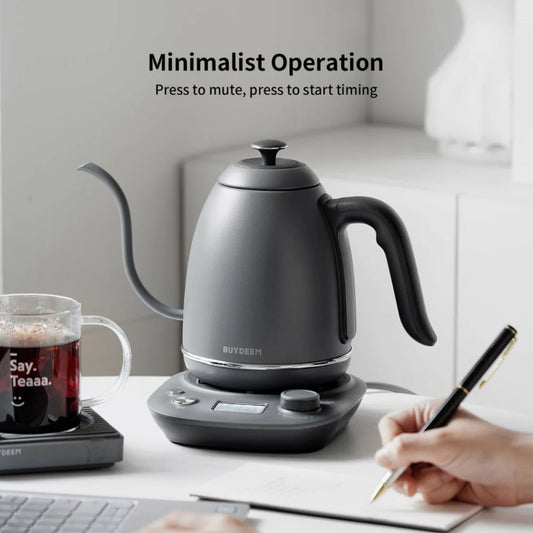 Buydeem minimalist electric gooseneck kettle in matte grey on office desk, featuring timing and mute function for making tea or coffee, modern workspace setting