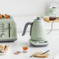 Buydeem mint green electric kettle and toaster on white kitchen counter, stylish breakfast setup with coffee, pastry, and jam in a bright modern home