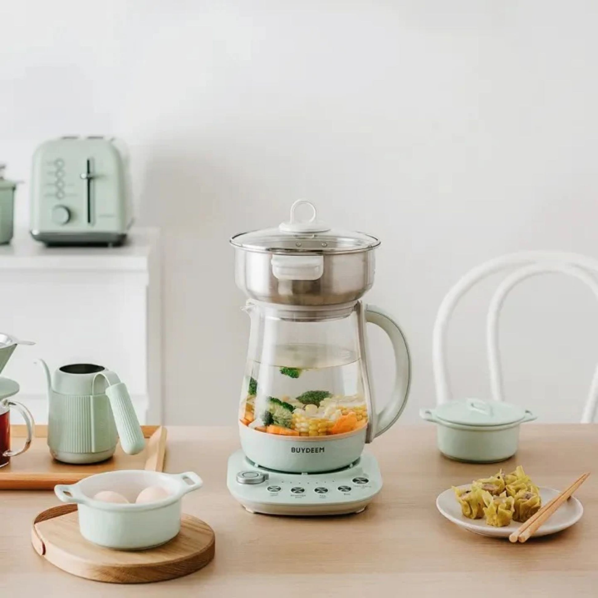 Buydeem Multi-Functional 4-in-1 Health Pot with steamer cooking soup and vegetables, modern kitchen breakfast setup