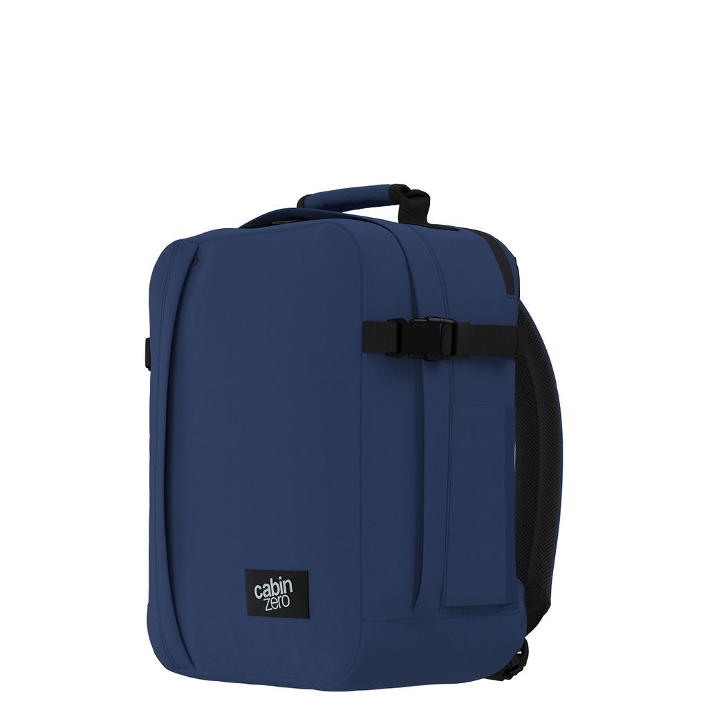 Back view of CabinZero Classic Tech Bag 28L in Navy Blue featuring padded adjustable shoulder straps, top handle, and side handle for ergonomic comfort and easy carrying.