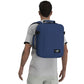 Man wearing CabinZero Classic Tech Bag 28L in Navy Blue, showcasing ergonomic shoulder straps and minimalist design—perfect for tech-savvy travelers and daily commuters