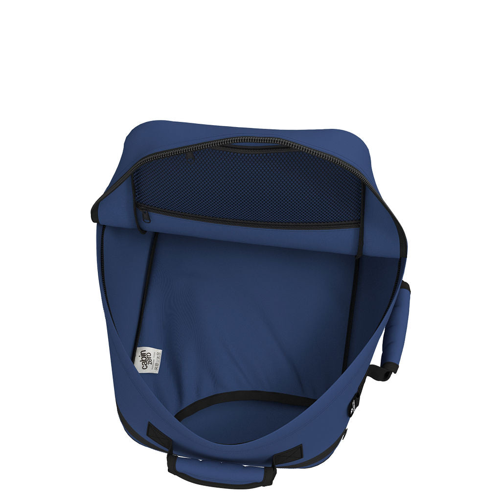 CabinZero Classic Tech Bag 28L in Navy Blue showing open main compartment and mesh pocket for organized packing and easy access to travel or tech essentials