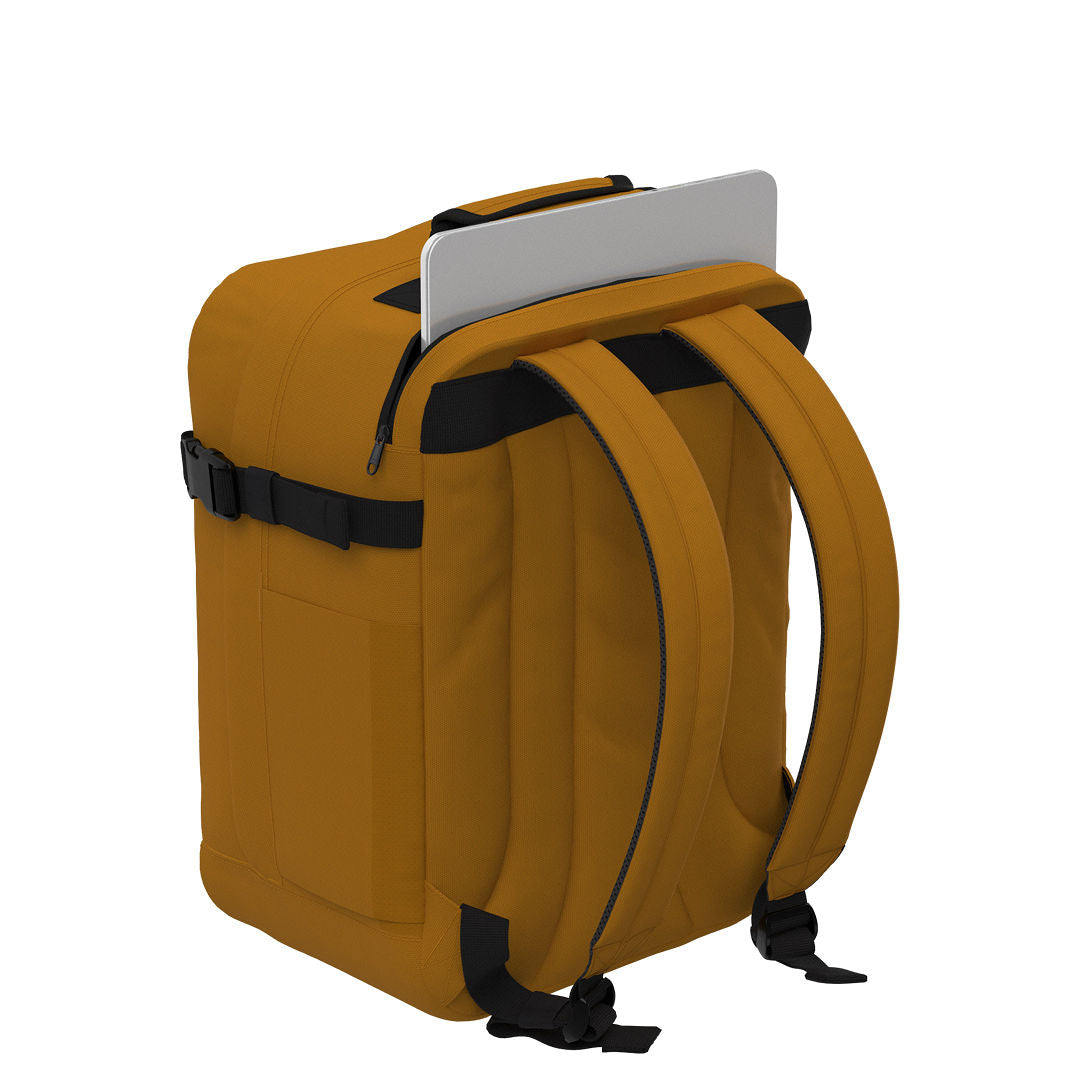 CabinZero Classic Tech Bag 28L in Orange Chill showing dedicated rear laptop compartment and padded shoulder straps for secure tech storage and comfortable day-to-day or travel use.