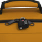 Close-up of CabinZero Classic Tech Bag 28L in Orange Chill featuring lockable YKK zippers secured with a TSA-approved travel lock for added security during commutes and trips