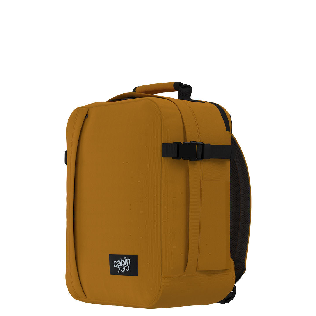 Side angle view of CabinZero Classic Tech Bag 28L in Orange Chill featuring compression strap, padded back, and clean silhouette—ideal backpack for tech essentials, commuting, and travel adventures.