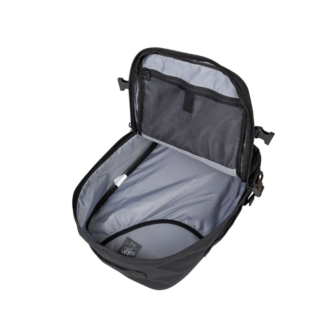 CabinZero Classic black travel backpack with main compartment open, showing spacious interior, laptop sleeve, and mesh organizer pocket for efficient travel packing.