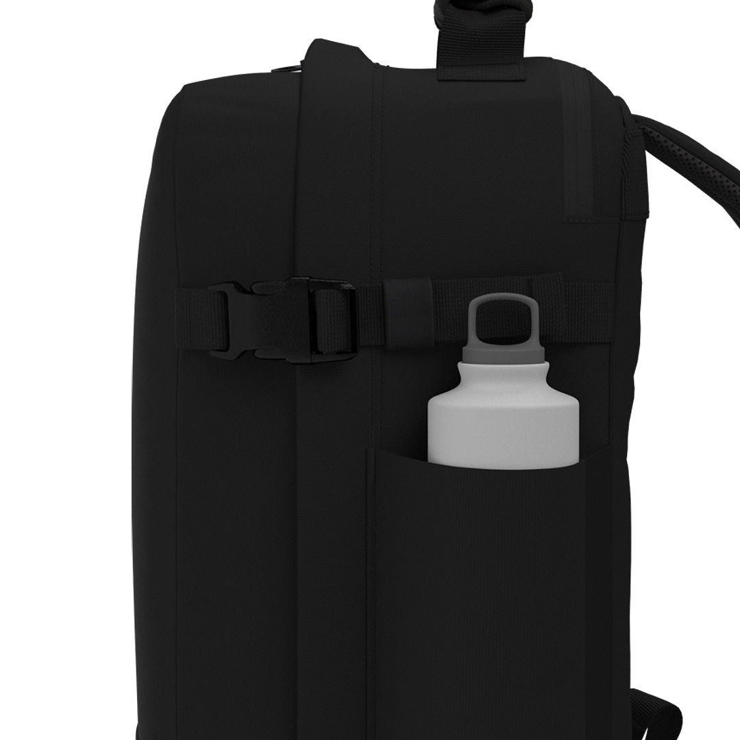 CabinZero Classic Tech Bag 28L in Absolute Black featuring side water bottle pocket and adjustable compression strap for easy hydration and functional travel organization.