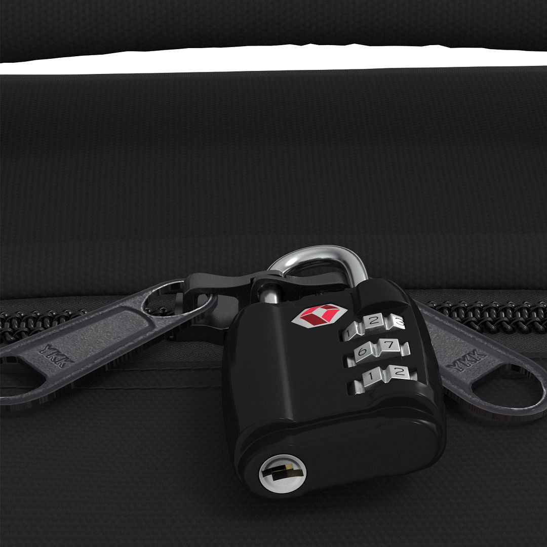 Close-up of CabinZero Classic Tech Bag 28L in Absolute Black showing lockable YKK zippers secured with a TSA travel lock for enhanced security during trips and commutes.