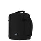 Side angle view of CabinZero Classic Tech Bag 28L in Absolute Black showing compression straps, padded back panel, and compact design—ideal backpack for travel, tech gear, and daily carry