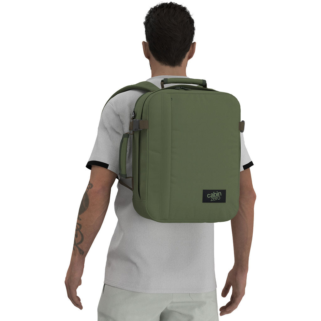 Man wearing CabinZero Classic Tech Bag 28L in Georgian Khaki, featuring ergonomic shoulder straps and minimalist design—ideal backpack for tech-savvy travelers, commuting, and everyday use