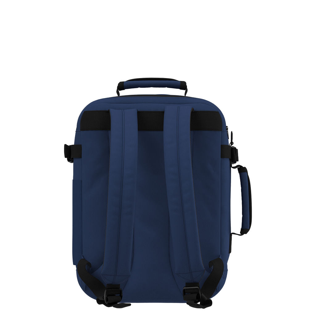 Back view of CabinZero Classic Tech Bag 28L in Navy Blue featuring padded adjustable shoulder straps, top handle, and side handle for ergonomic comfort and easy carrying.