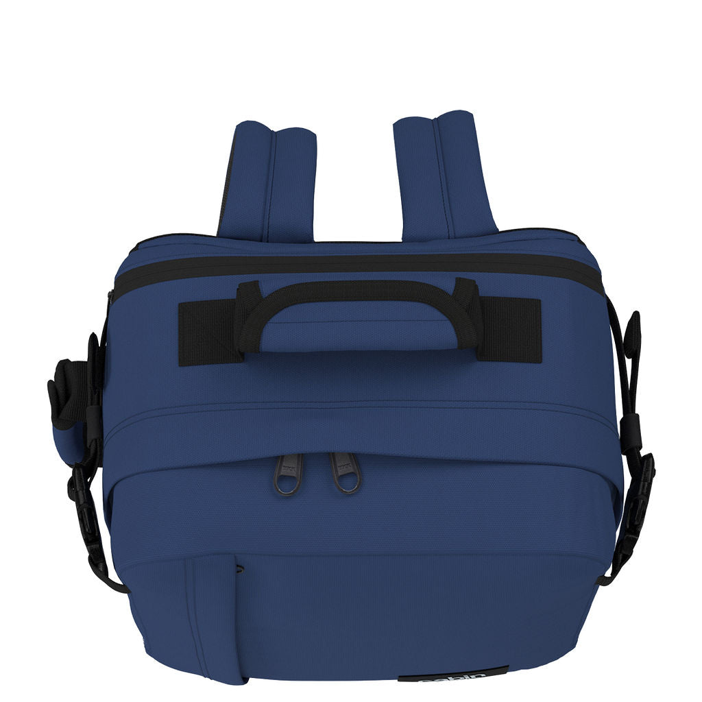 Top view of CabinZero Classic Tech Bag 28L in Navy Blue highlighting padded carry handle, dual zipper openings, and adjustable shoulder straps for easy access and travel convenience.