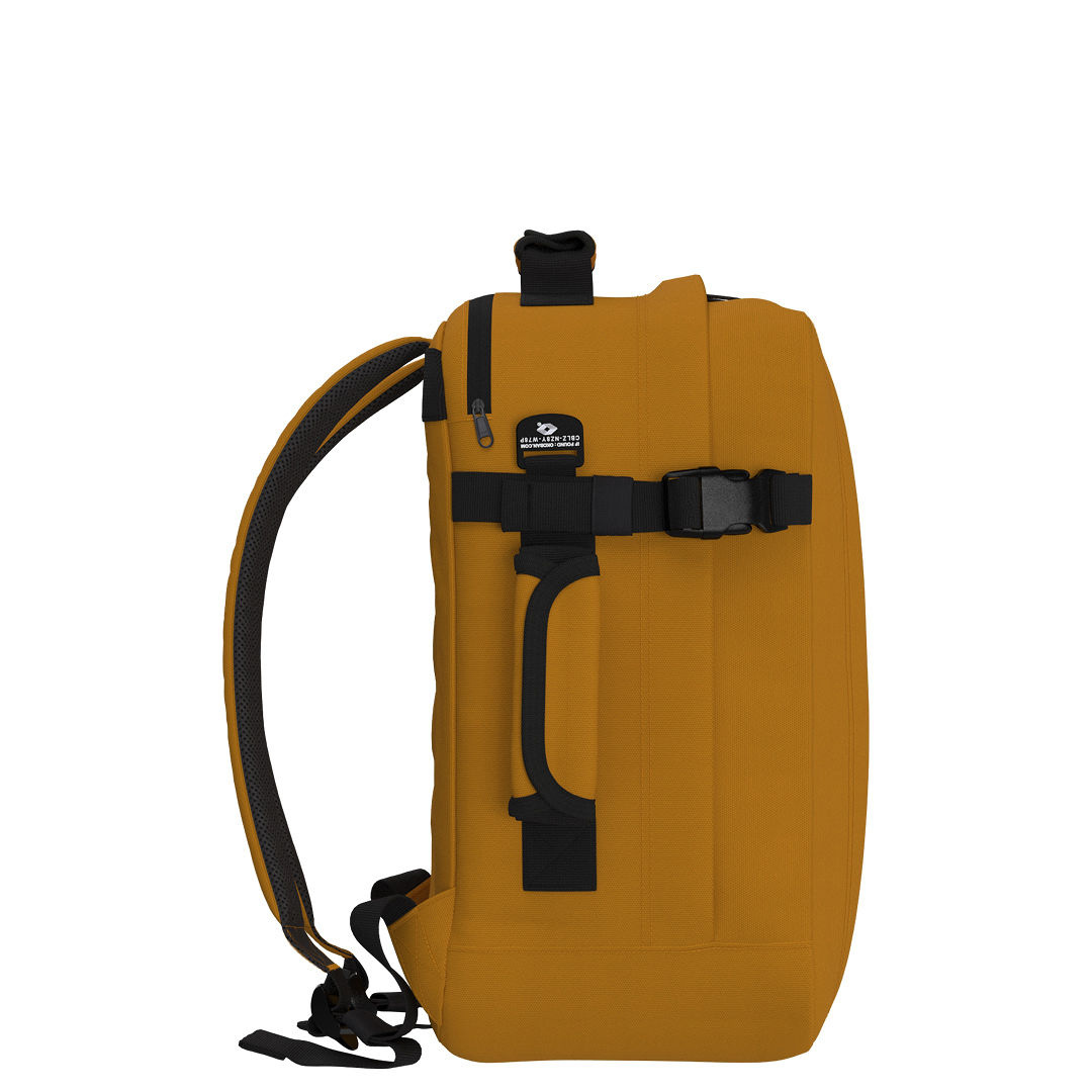 Side view of CabinZero Classic Tech Bag 28L in Orange Chill highlighting adjustable compression straps, padded side handle, and ergonomic shoulder straps for comfortable travel and daily use.