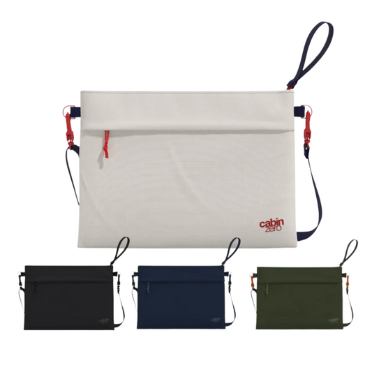 Four CabinZero Sacoche pouches in different colors (white with red zipper and blue strap, black, navy blue, and olive green) displayed on a white background. The main white pouch is shown prominently above the three smaller pouches.