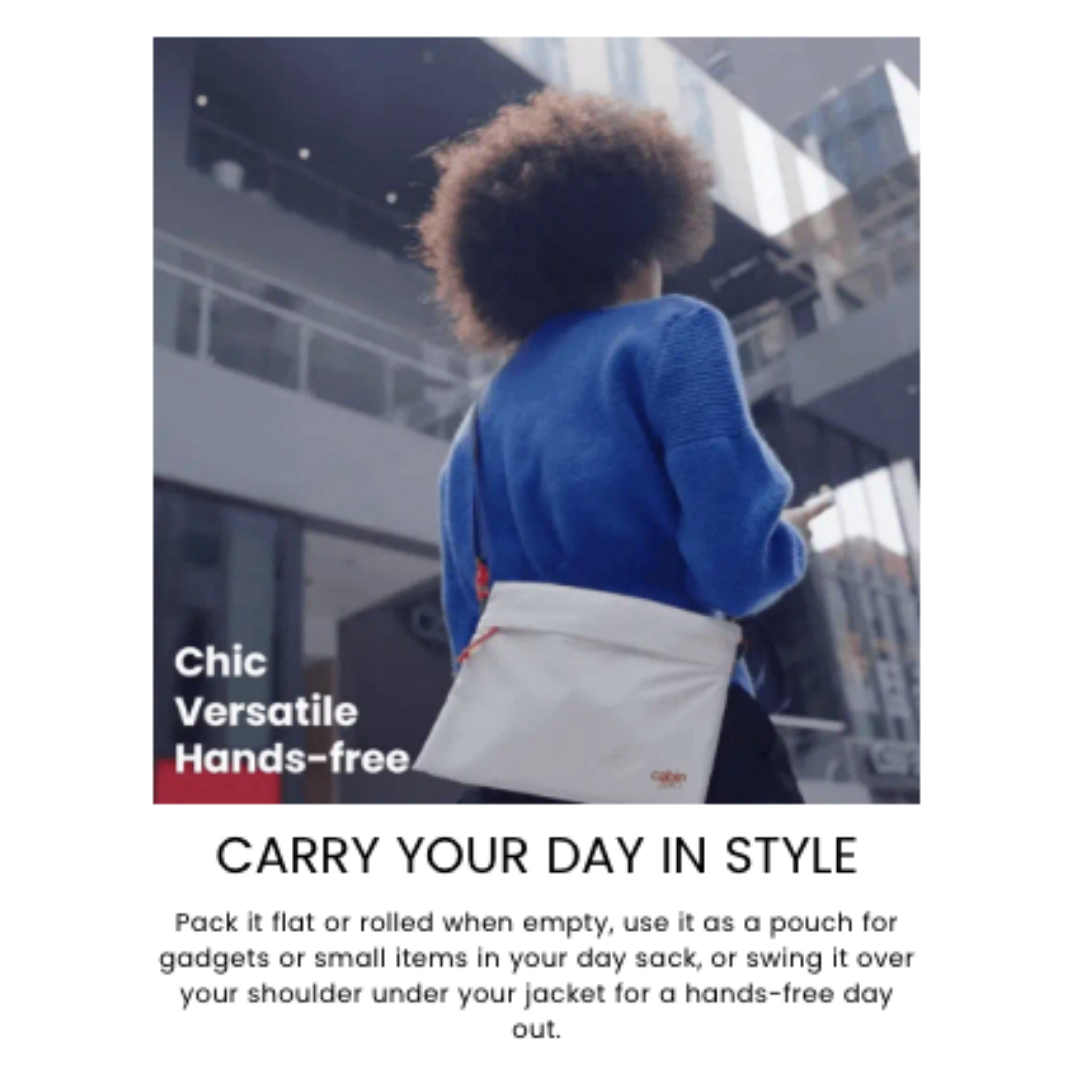 Person wearing a bright blue sweater and carrying a white CabinZero Sacoche pouch with a red zipper and navy strap, walking in a modern urban environment. Text overlay reads "Chic Versatile Hands-free.