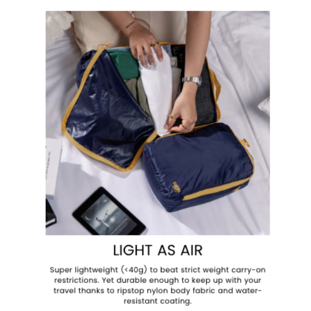 CabinZero ULTRALIGHT PACKING CUBE Large 12.5L Blue Shimmer in use—packable, ultralight travel organizer with durable ripstop nylon and water resistance