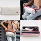 Collage of four images featuring a white CabinZero pouch with red zipper and blue strap: top left shows the pouch on a plain background, top right displays a person unzipping the pouch while seated, bottom left shows the pouch worn crossbody by a person in a tan shirt, and bottom right reveals the pouch open with various travel items organized inside
