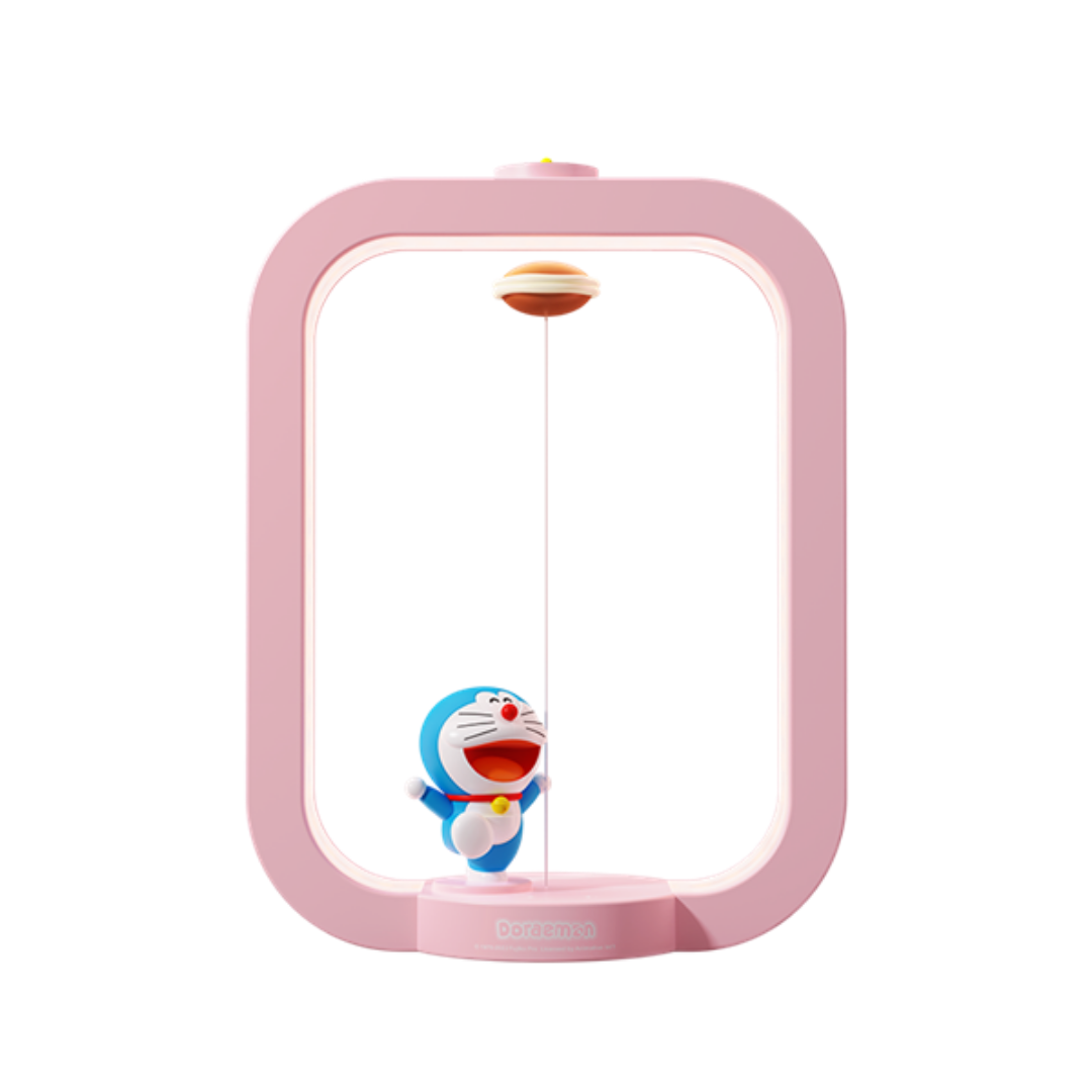 Pink Doraemon Dorayaki magnetic levitation night light featuring a smiling Doraemon figure and floating dorayaki, modern design, isolated on white background.