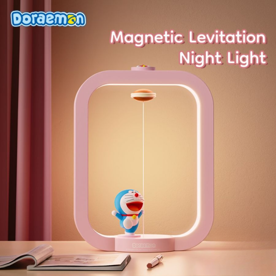 Pink Doraemon Dorayaki magnetic levitation night light featuring a smiling Doraemon figure and floating dorayaki, with soft LED glow on a desk setting