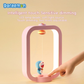 Hand touching the base of a pink Doraemon Dorayaki magnetic night light with intelligent touch-sensitive dimming, featuring a soft LED light and smiling Doraemon figure inside a modern frame.