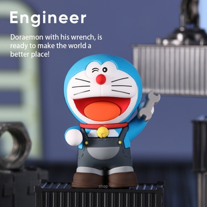 Doraemon collectible engineer figure winking and holding a silver wrench, dressed in overalls, standing on a black platform with industrial props and "Engineer: Doraemon with his wrench, is ready to make the world a better place!" text above