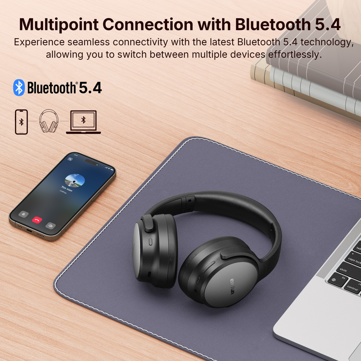 Black EarFun Tune Pro headphones resting on a desk mat between a smartphone and laptop, with text promoting multipoint Bluetooth 5.4 connectivity and the ability to switch between multiple devices effortlessly.