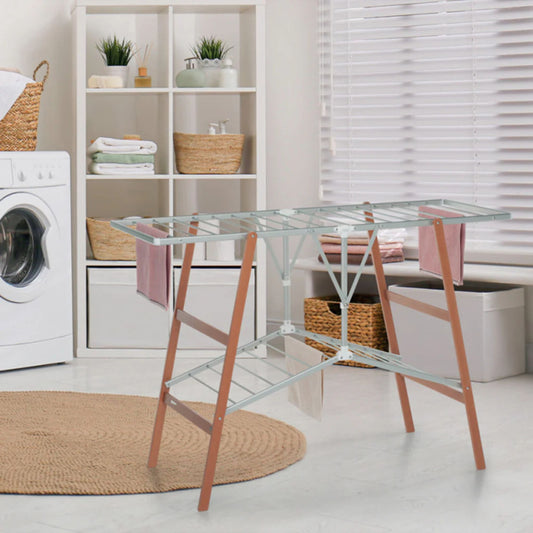 Foppapedretti Ciak Beechwood and Aluminium Drying Rack set up in a modern laundry room with towels hanging