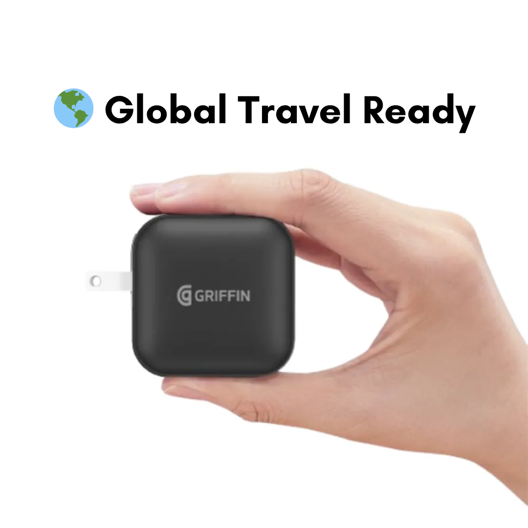 Hand holding Griffin 70W GaN global travel-ready USB-C charger, compact design for international charging compatibility.